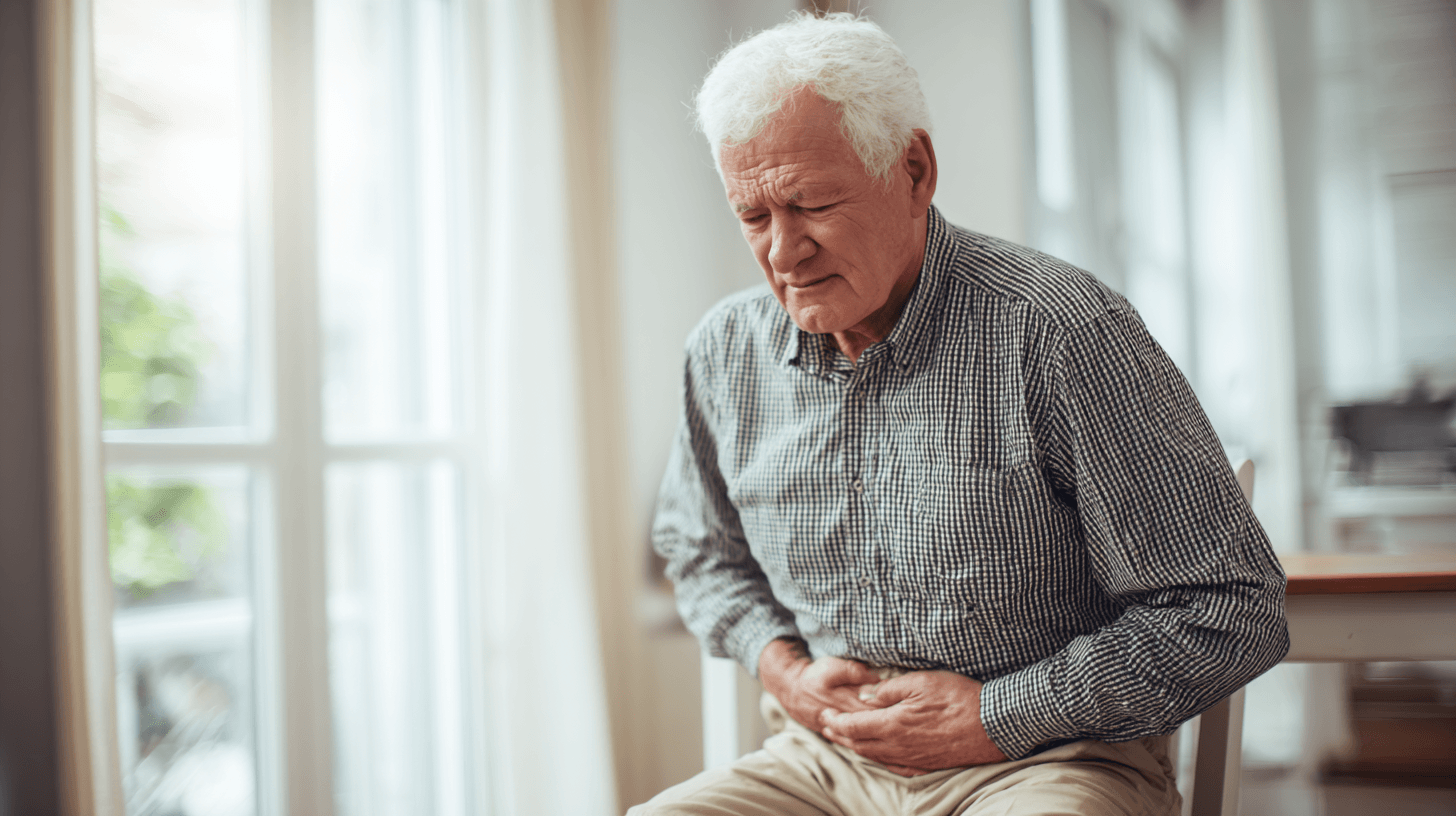 mann haelt sich bauch vor schmerzen, symbol für verstopfung